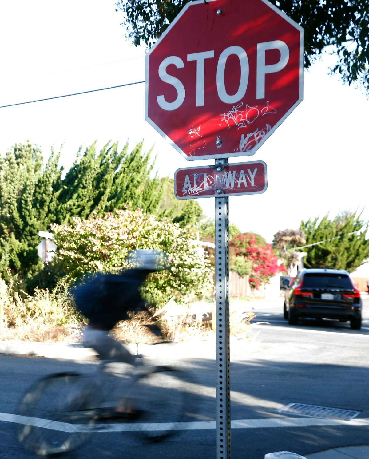 A blcyclist rolls through a stop sign at Bancroft Way and California Street in Berkeley, Calif. on Wednesday, Sept. 11, 2019. Berkeley Police are issuing $300 citations to bicyclists who blow through stop signs or red lights.