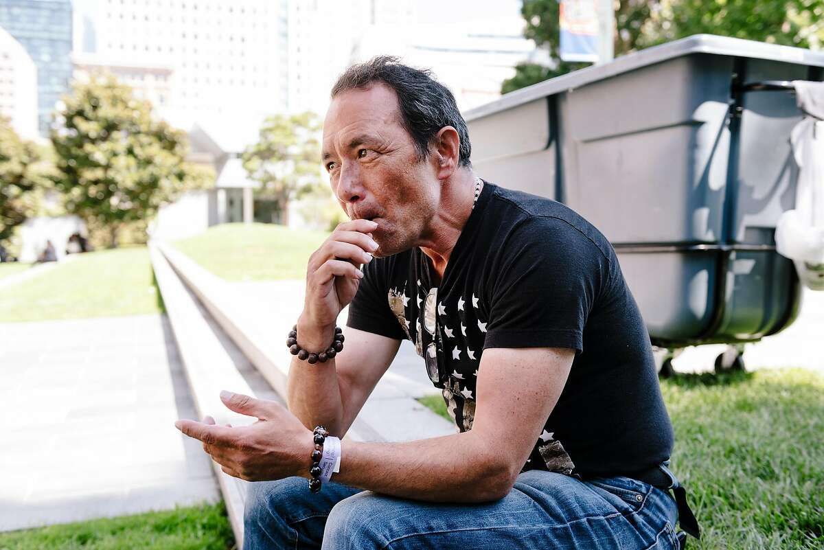 John Petitt uses a Juul vape pen while sitting in Yerba Buena Gardens in San Francisco, Calif. on Wednesday, Sept. 11, 2019. John started using a Juul vaporizer 2 years ago to help him quit his 30 year addiction to smoking cigarettes.