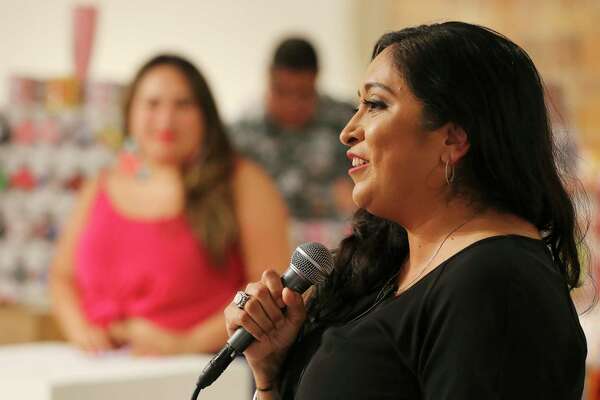 Melanie Mendez-Gonzales of “Que Means What” greets the audience at an event she organized at Brick in the Blue Star Arts Complex in August. Mendez-Gonzales said she uses her brand to boost interest in local Latina-owned businesses.