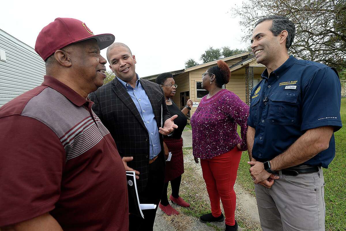 Texas Land Commissioner George P. Bush jokes with Port Arthur councilman Cal Jones and Mayor Derrick Freeman as area GLO employee Rhonda Masters talks with homeowner Havalisia Owens about obtaining assistance during a stop in Jefferson County Wednesday. The Texas General Land Office rolled out their newest Homeowner Assistance Program in the region to further aid those still recovering from Tropical Storm Harvey. They also announced a FEMA extension on trailers as well as a new sales program. Photo taken Wednesday, November 28, 2018 Kim Brent/The Enterprise