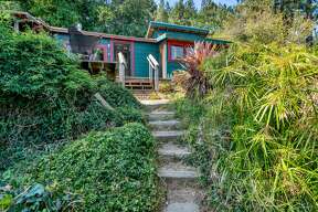 Circa 1918, this tiny cabin in the treetops with killer Mt. Tam and bay views wants 599K