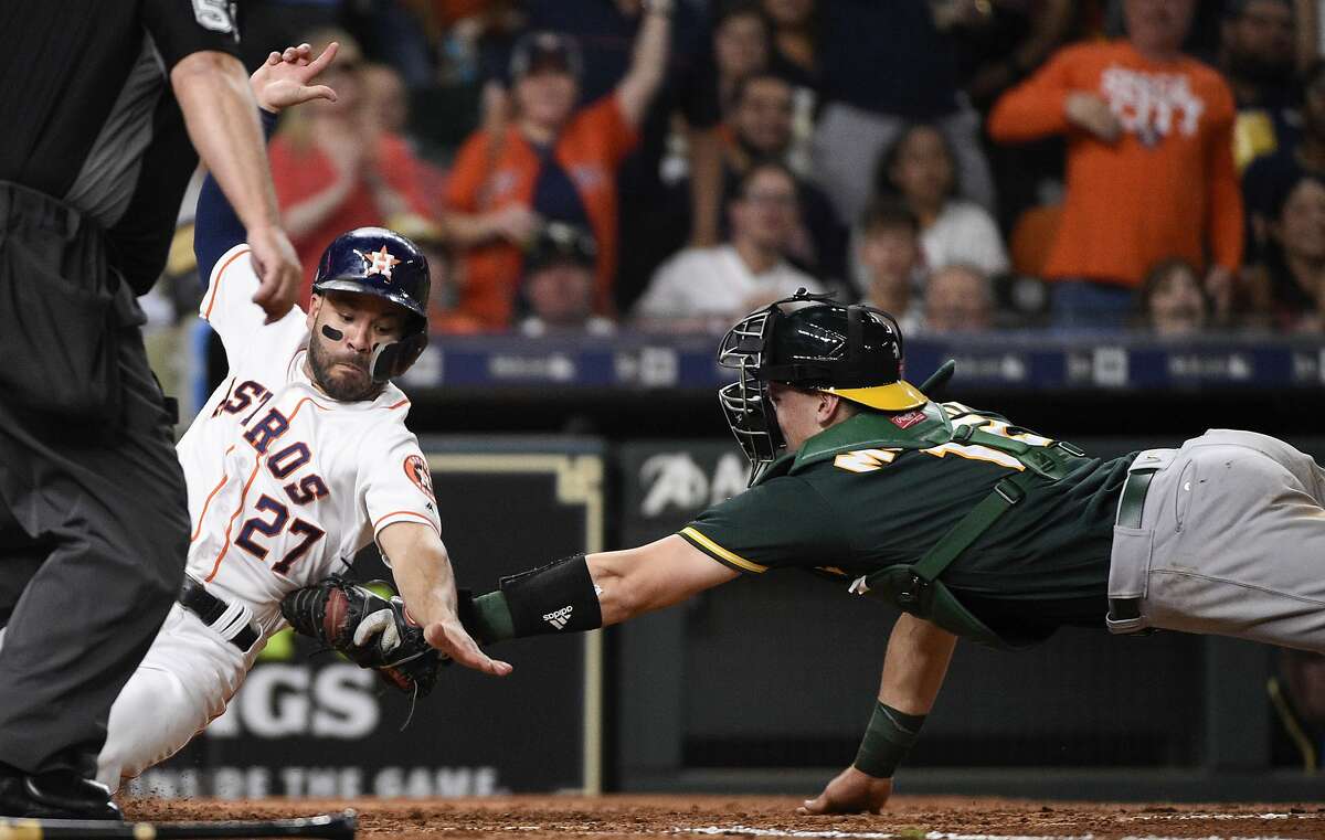 Houston Astros' Jose Altuve (27) is tagged out at home by Oakland Athletics catcher Sean Murphy during the fifth inning of a baseball game, Wednesday, Sept. 11, 2019, in Houston. (AP Photo/Eric Christian Smith)