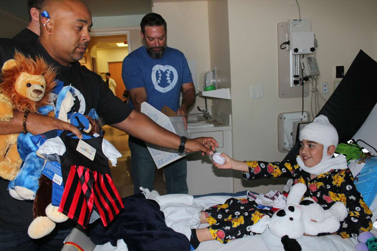 MLB umpire and Houston native Adrian Johnson and crew members visit young patients at Memorial Hermann Children's Hospital.
