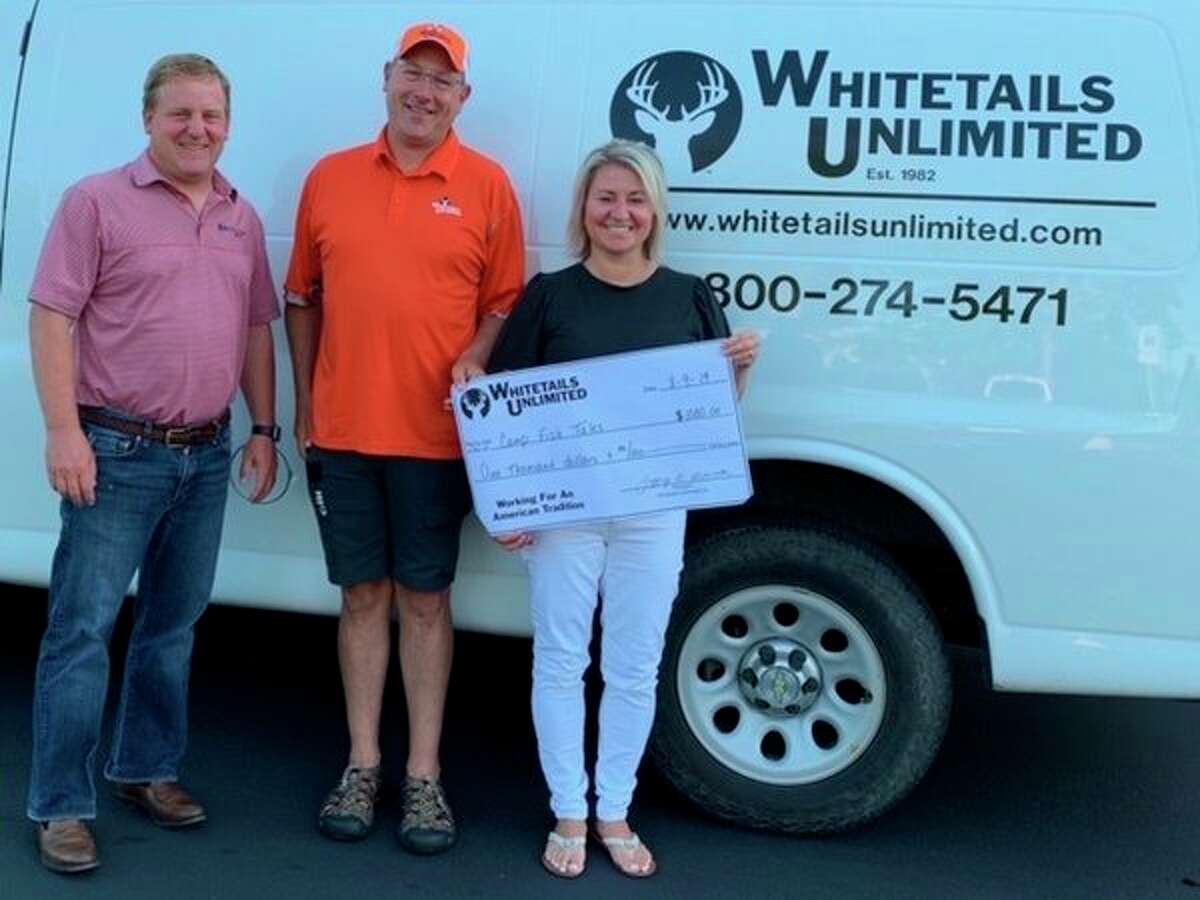 From left, Camp Fish Tales Board Member Karl Ieuter, Jason Maraskine of Whitetails Unlimited, and Camp Fish Tales Executive Director Shannon Forshee pose for a photo with a $1,000 grant from Whitetails, to go toward improving the camp's archery program. (Provided photo)