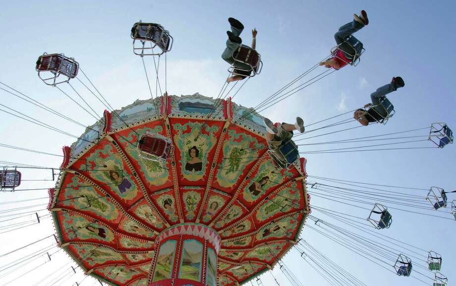 Patrons ride the swings at the Myrtle Beach Pavilion in Myrtle Beach, S.C. Photo: AP / AP