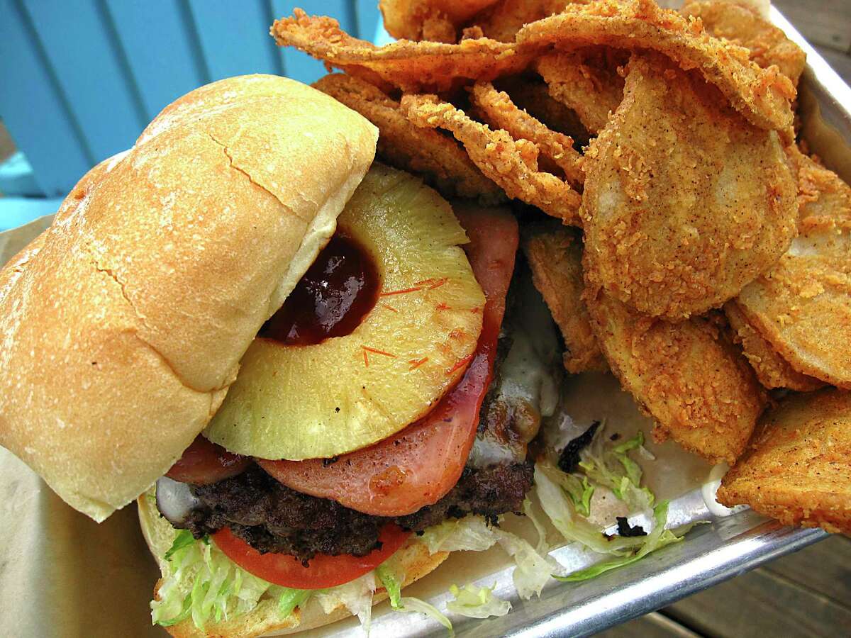The Big Kahuna Burger includes Spam and pineapple at Lucy Cooper's Ice House. Shown with a side order of spicy breaded Rojo Fries.