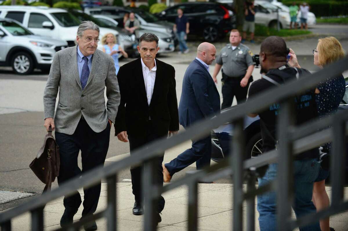 Fotis Dulos, center, arrives with his attorney Norm Pattis, left, for arraignment on a new tampering with evidence charge Thursday, September 12, 2019, at state Superior Court in Norwalk, Conn.