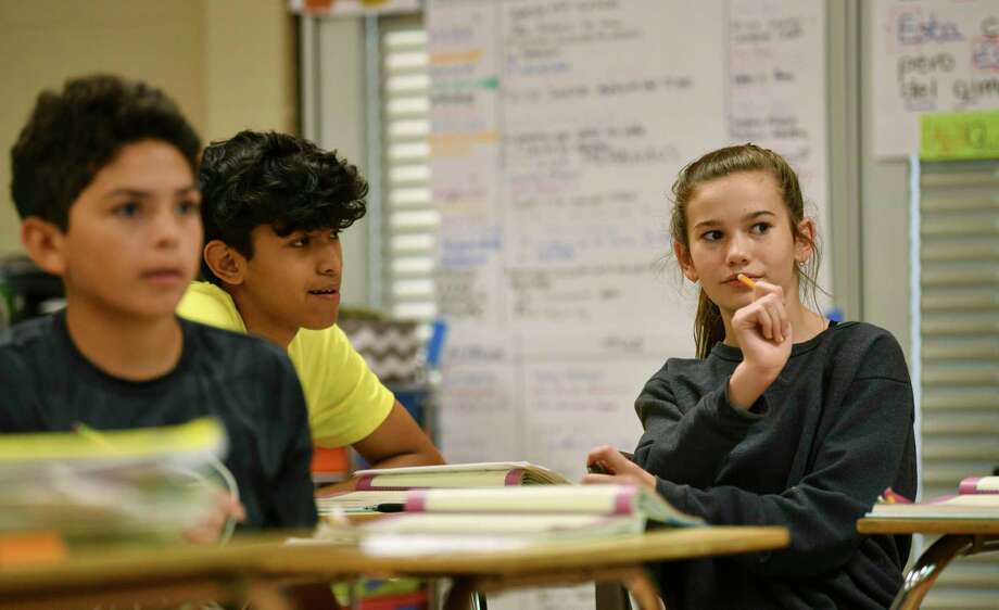 Carli Wilson, right, is a dual language student at Lopez Middle School. She is the only Spanish speaker in her family and often translates emails for her father's work. Photo: Billy Calzada / Billy Calzada