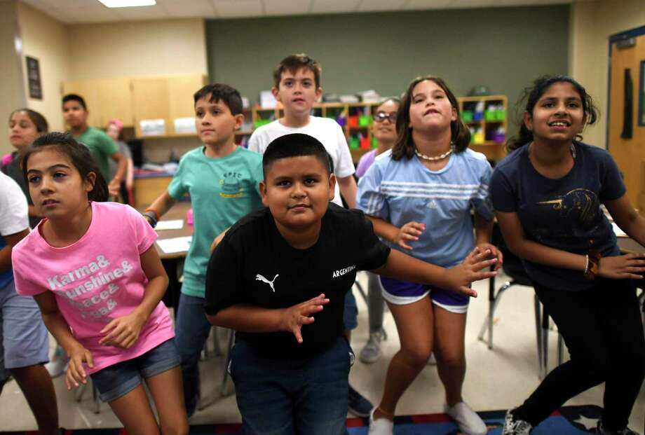 Luis Fabela, center, dances with classmates in fifth grade classroom at Ellison Elementary School. Luis transferred earlier this year to Ellison, where the dual language program hasn't yet reached fifth grade. Luis was placed in a class with bilingual students so he'd continue to learn Spanish. Photo: Billy Calzada / Billy Calzada