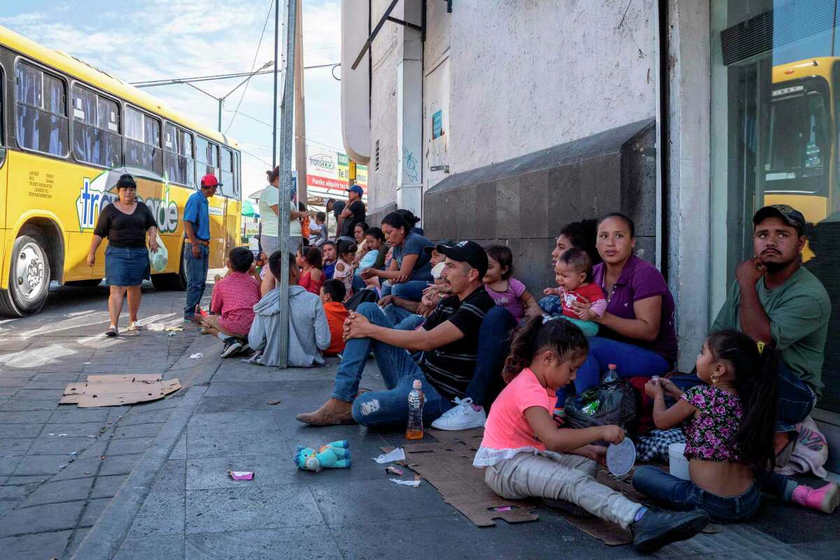 Migrants, mostly from Mexico, are pictured sitting on the ground waiting near the Paso del Norte Bridge at the Mexico-US border, in Ciudad Juarez, Mexico, on September 12, 2019. - The US Supreme Court on September 11, 2019, allowed asylum restrictions by President Donald Trump's administration to take effect, preventing most Central American migrants from applying at the US border. (Photo by Paul Ratje / AFP)PAUL RATJE/AFP/Getty Images