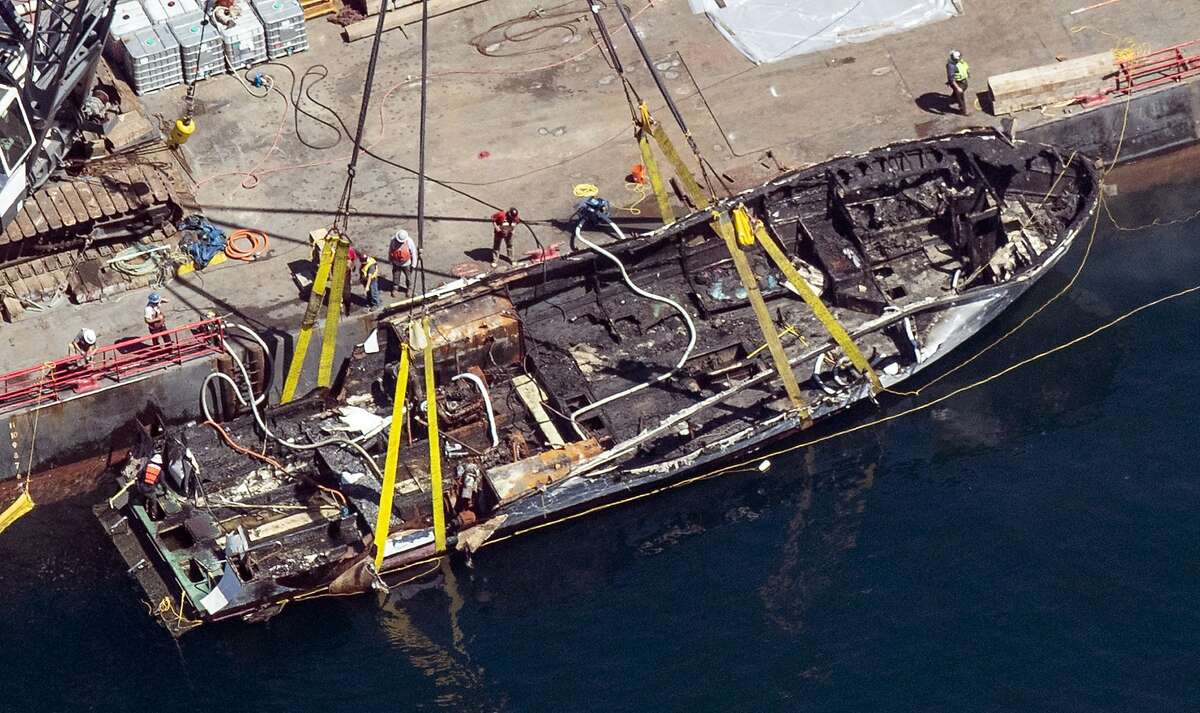 The burned hull of the Conception is brought to the surface by a salvage team, Thursday, Sept. 12, 2019, off Santa Cruz Island, Calif., in the Santa Barbara Channel in Southern California The vessel burned and sank on Sept. 2, taking the lives of 34 people aboard. Five survived. (Brian van der Brug/Los Angeles Times via AP)