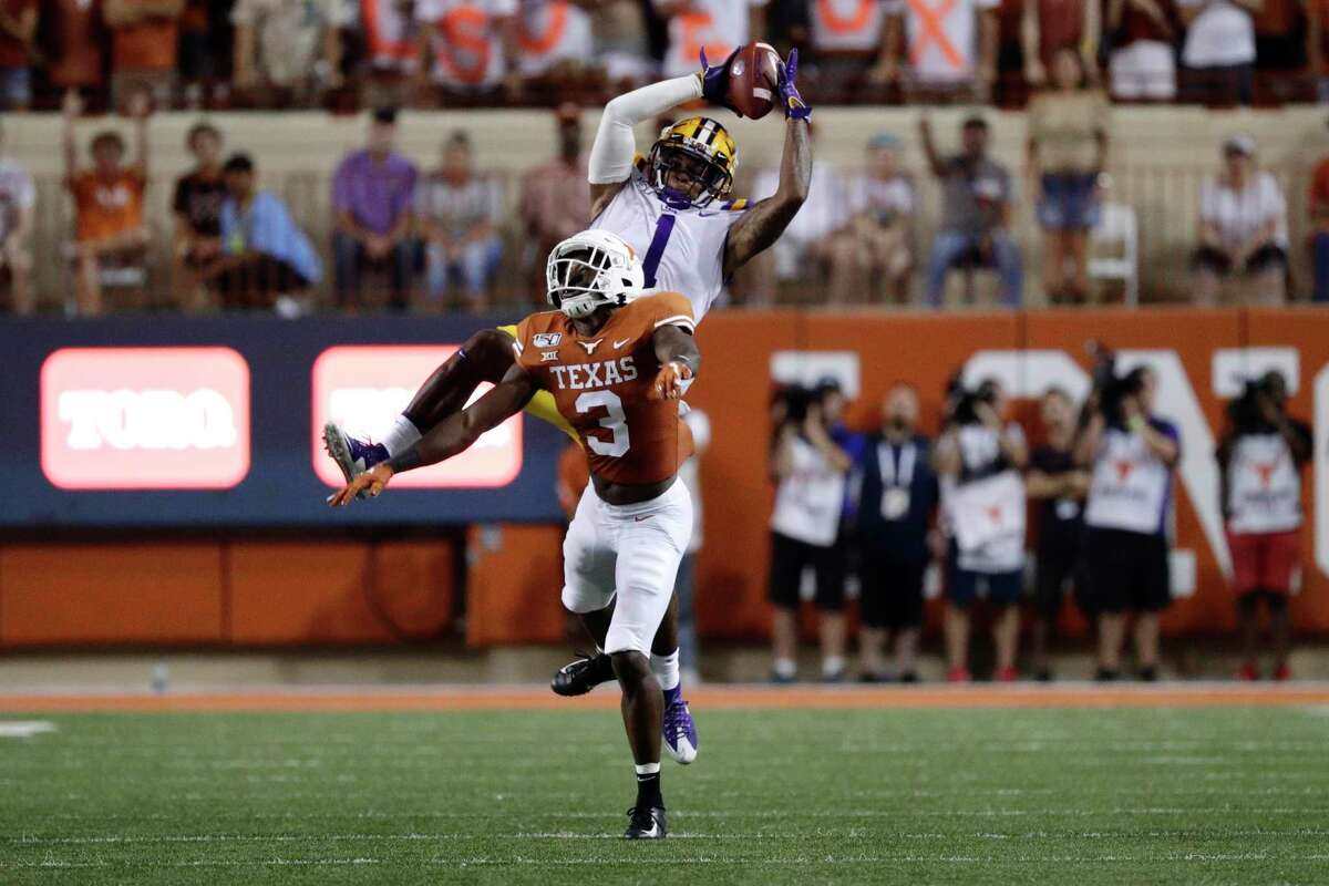 LSU’s Ja’Marr Chase catches a pass over Texas’ Jalen Green. The Tigers racked up 573 yards of offense in Saturday’s game.