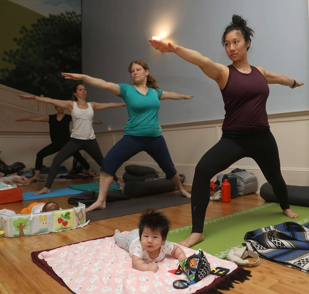 Emma (left), 12 weeks old, takes mom and baby yoga class with her mom Amanda Chau from San Francisco,at Yoga Tree on Friday, Sept. 6, 2019 in San Francisco, Calif.