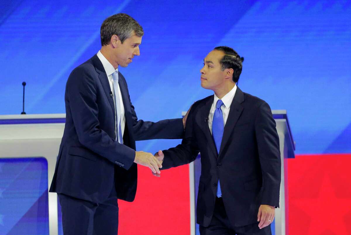 Democratic presidential candidates former U.S. Rep. Beto O’Rourke and former Housing Sec. Julian Castro welcome each other to the stage during the Democratic presidential debate inside Texas Southern University's Health & PE Arena in Houston, Thursday, Sept. 12, 2019.