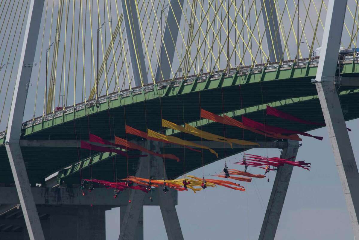 Eleven Greenpeace USA protesters are dangling from the northbound of the Fred Hartman Bridge to protest against the oil industry on Thursday, Sept. 12, 2019, in Baytown. Another 11 spotter for those protesters are sitting on the bridge. Protestors said they are intending to protest for 24 hours.