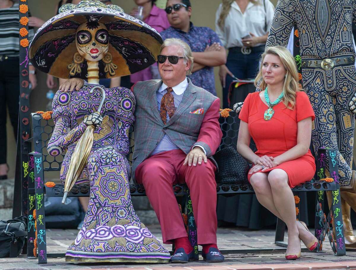 Robert ÒDickÓ Tips, left, jokingly puts his arm around a day of the dead decoration while his wife, Kristin sits next to him Thursday, Sept. 12, 2019 at La Villita during a news conference announcing a new city-sponsored Day of the Dead celebration.