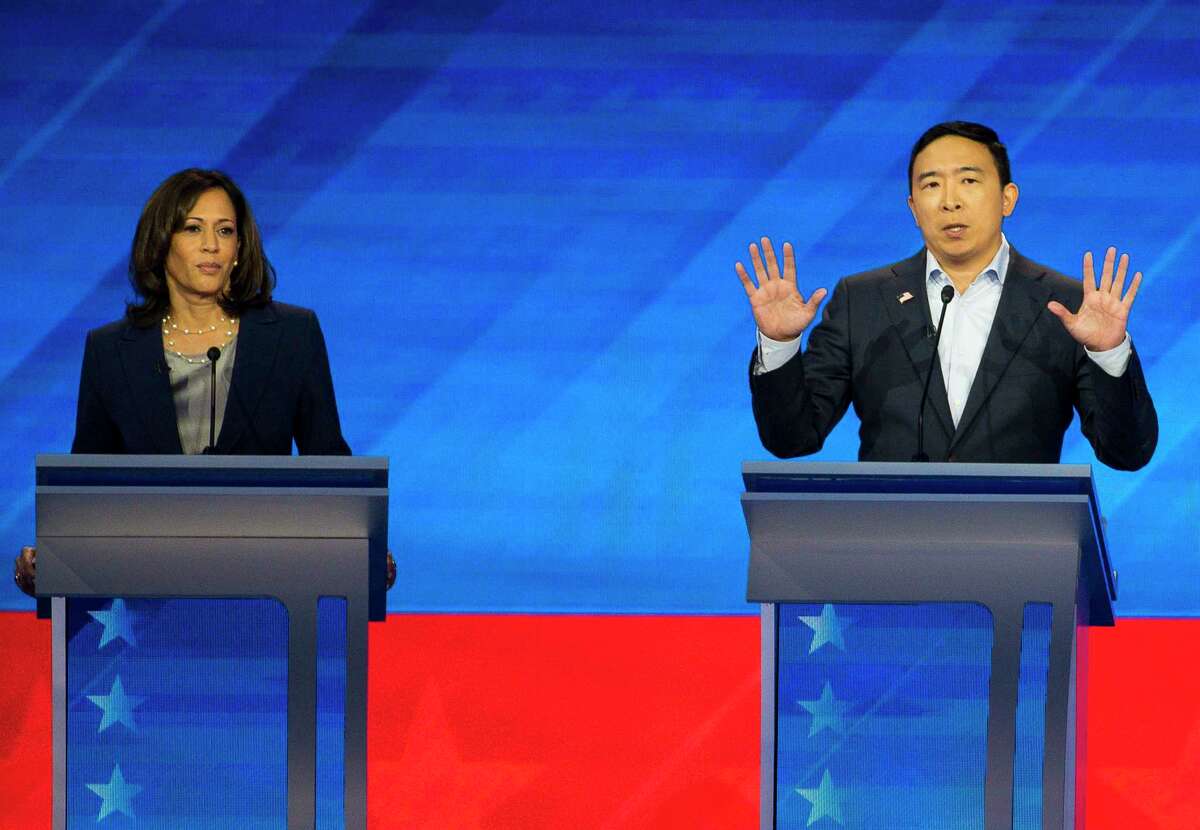 FILE - Democratic presidential candidate entrepreneur Andrew Yang speaks next to Sen. Kamala Harris, D-Calif., during the Democratic presidential debate inside Texas Southern University's Health & PE Arena in Houston, Thursday, Sept. 12, 2019. The latest Emerson poll shows that Yang is leading Harris in her home turf of California.