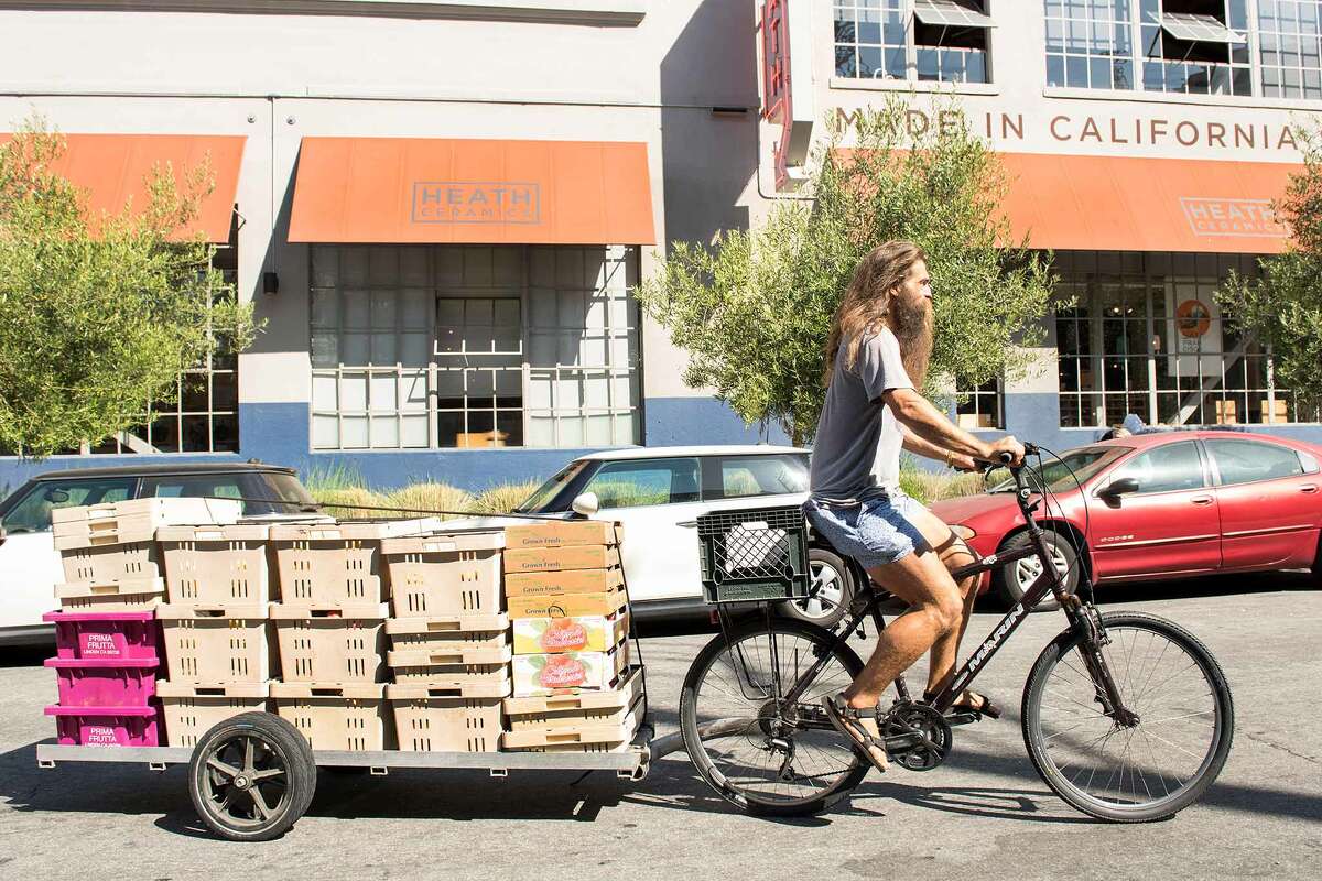 Konstantin Kosov rolls up to his first fruit delivery of the day, Heath Ceramics.