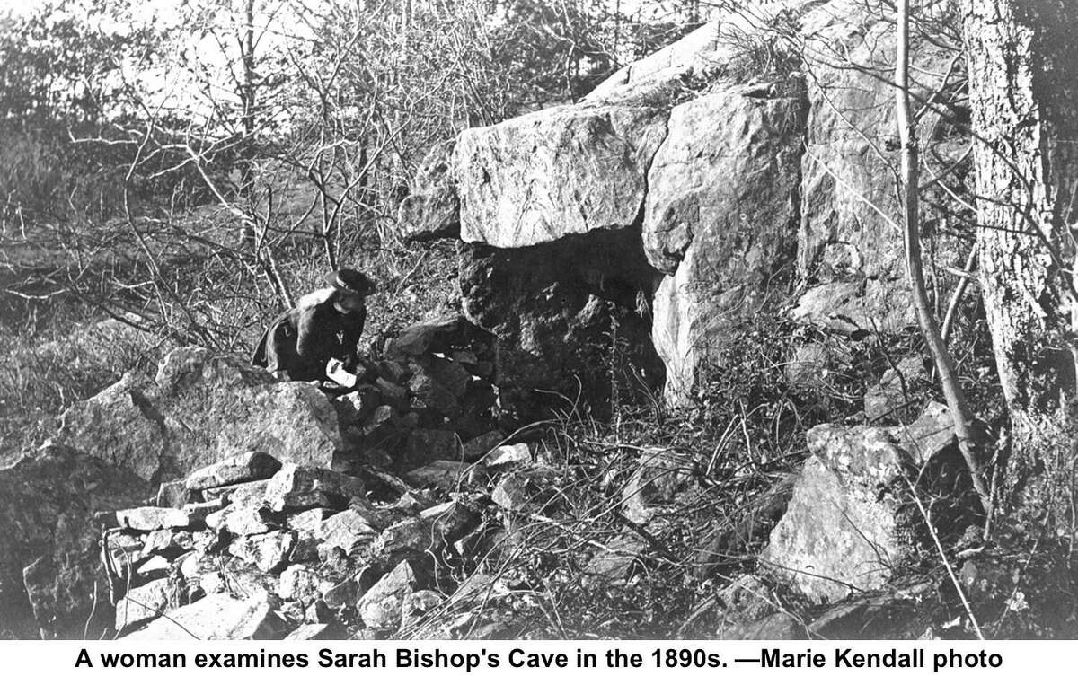 A woman examines Sarah Bishop’s Cave in the 1890s.