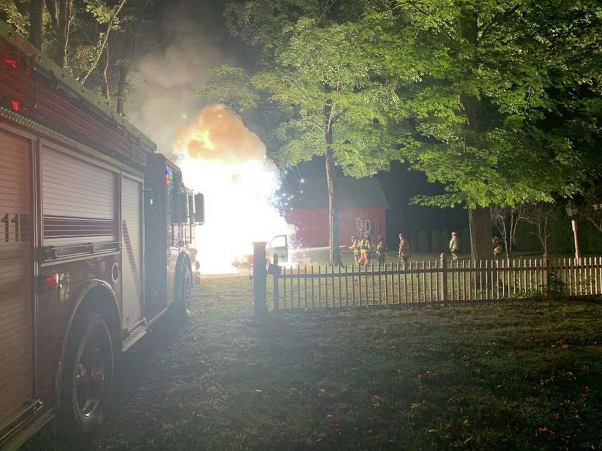 Southbury firefighters work to put out a raging van fire outside a Main Street North home the night of Sept. 12, 2019.