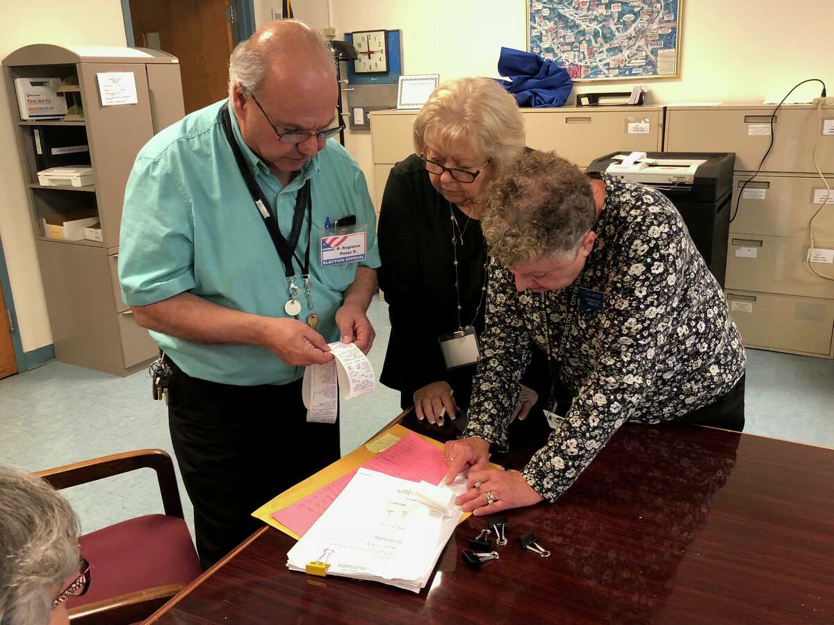 Republican Registrar Peter Pavone with Margaret Weber, center, and Sylvia Brody inspecting voting totals Friday, Sept. 13, during the Fourth Ward recanvassing.