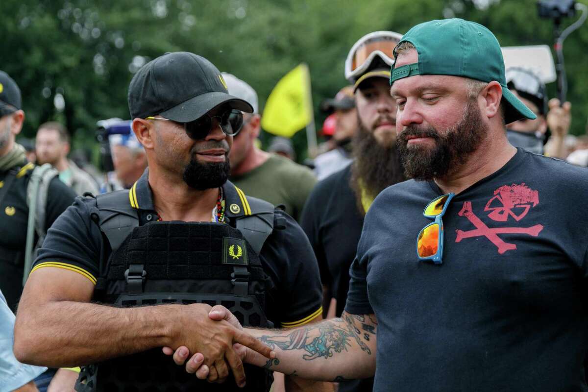 Leader of the Proud Boys Enrique Tarrio (L) and rally organizer Joe Biggs (R) congratulate each other as they return to the march starting-point over the Hawthorn Bridge as "The End Domestic Terrorism" rally at Tom McCall Waterfront Park concludes on August 17, 2019 in Portland, Oregon. - No major incidents were reported on Saturday afternoon in Portland (western USA) during a far-right rally and far-left counter-demonstration, raising fears of violent clashes between local authorities and US President Donald Trump, who was monitoring the event "very closely". (Photo by John Rudoff / AFP)JOHN RUDOFF/AFP/Getty Images