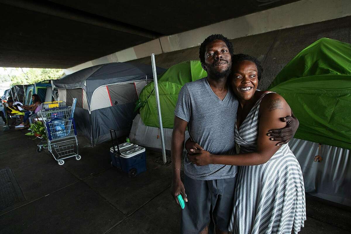 Edwin Williams, 31, and friend Michelle Vaughn, 24, are photographed at a homeless encampment located under the 118 fwy in Pacoima, Calif. on July 22, 2019. Caltrans wants to oust everyone from this location, but it has been delayed due to a legal challenge. (Mel Melcon/Los Angeles Times/TNS)