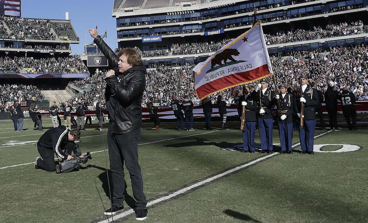 FILE - In this Dec. 24, 2016 file photo, Eddie Money performs the national anthem before an NFL football game between the Oakland Raiders and the Indianapolis Colts in Oakland, Calif. Money, the husky-voiced, blue collar rock star known for such hits as "Two Tickets to Paradise" and "Take Me Home Tonight," has died at age 70 in Los Angeles. Publicist Cindy Ronzoni provided a statement from the family that says he died Friday, Sept. 13, 2019. (AP Photo/Marcio Jose Sanchez)