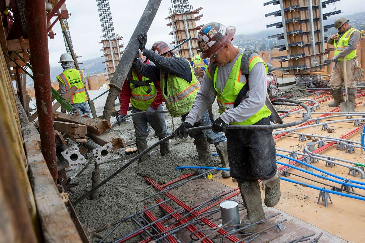 Construction workers pour a deck on the 24th floor of the MacArthur Commons construction site on Monday, July 8, 2019, in Oakland, Calif.