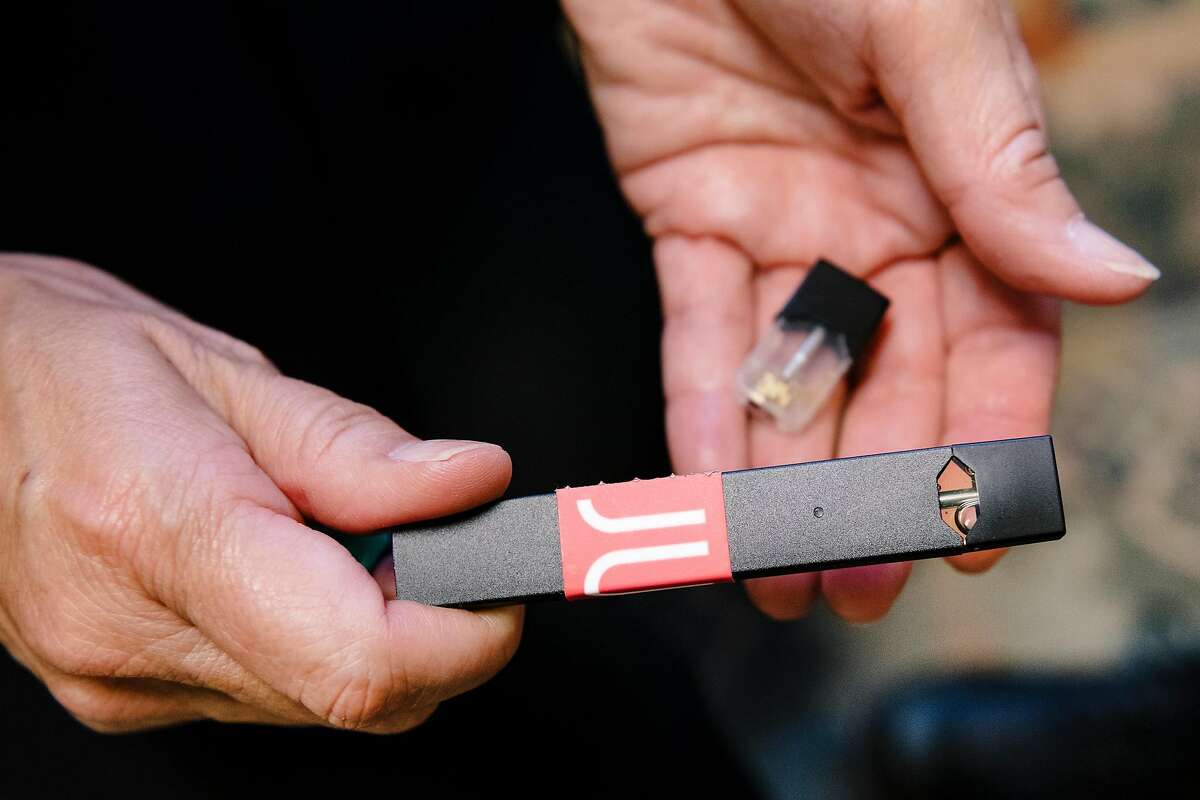 Wellness Center nurse Lynda Boyer-Chu holds a Juul vaporizer and cartridge she uses to help teach students the dangers of vaping, in her office at Washington High School in San Francisco, Calif, on Thursday, September 5, 2019.