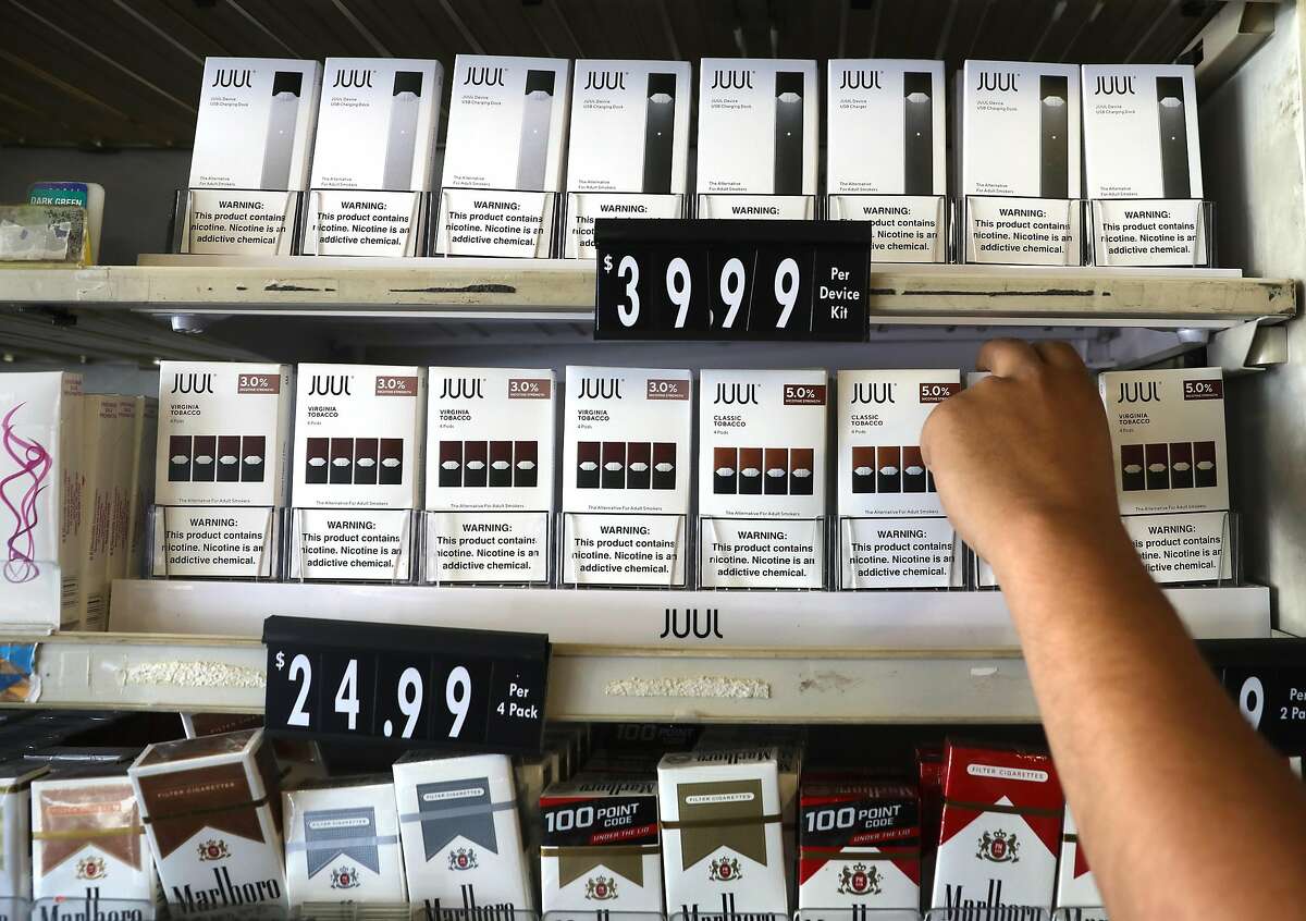 Owner Amit Oli at Haight Street Tobacco shows Juul products allowed for sale on his shelves on Thursday, Aug. 29, 2019, in San Francisco, Calif.