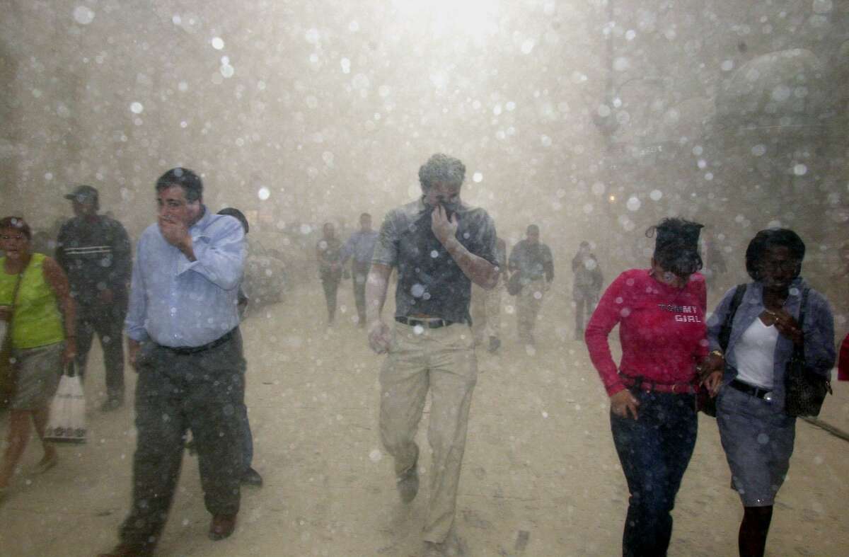 People run from the collapse of World Trade Center towers in this Sept. 11, 2001.