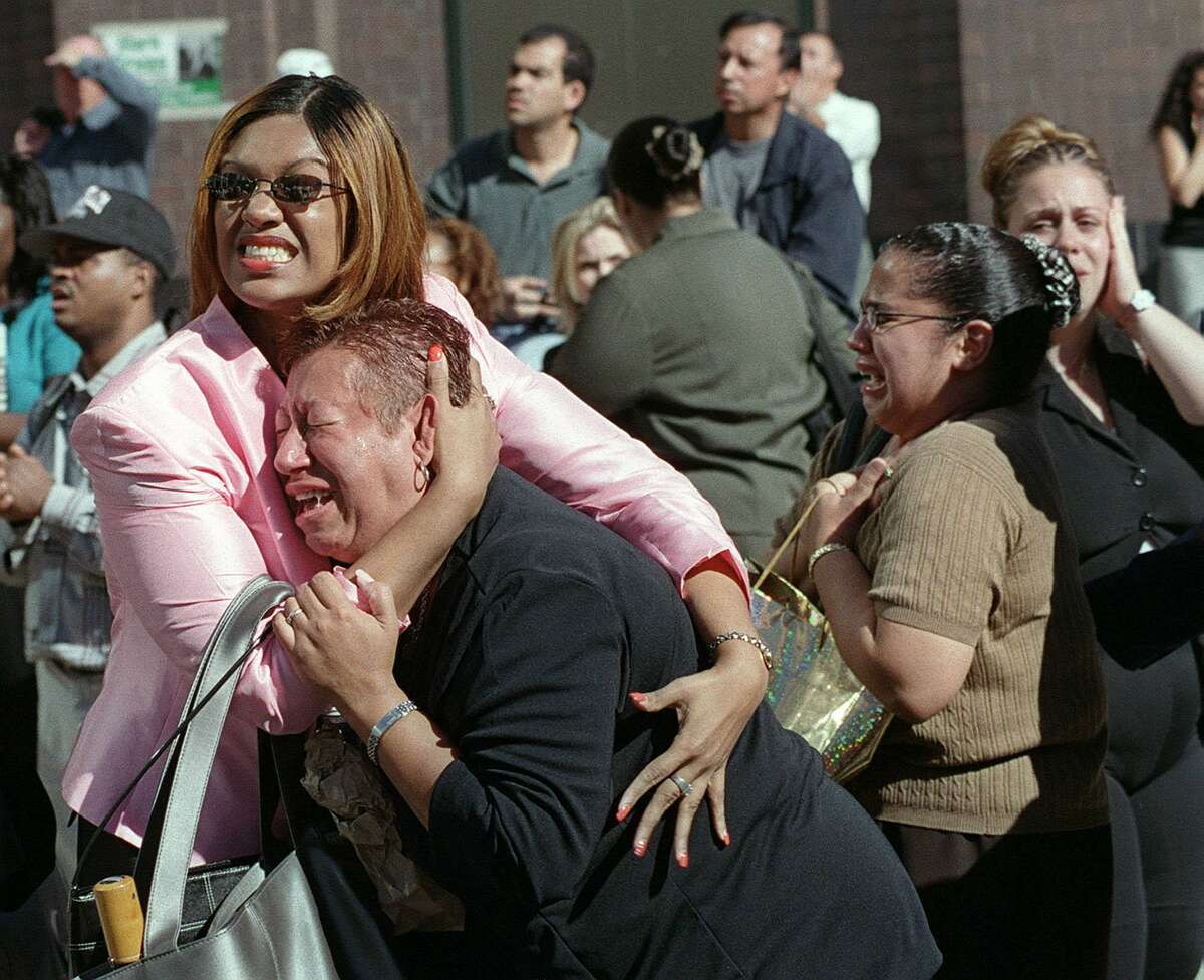 Two women hold each other as they watch the World Trade Center burn following a terrorist attack on the twin towers in New York, in this Sept. 11, 2001 file photo.