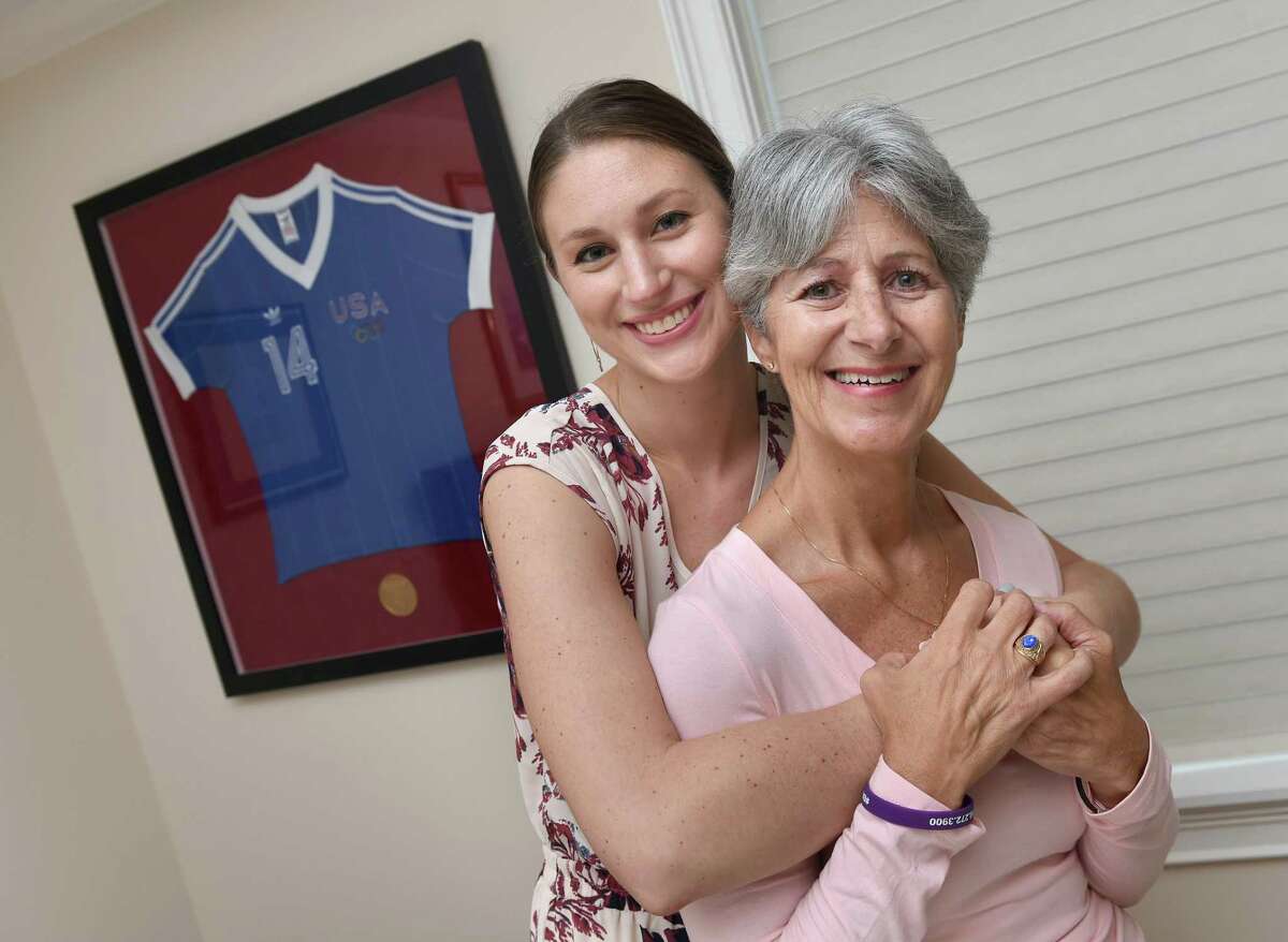 Kyley Reed, left, with her mother, Dorothy Franco-Reed, at her mother's home in Milford on Sept. 12, 2019. In the background is Franco-Reed’s jersey from the 1984 Olympic handball team.
