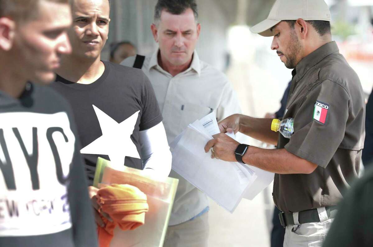 U.S. Immigration and Customs Enforcement officials return six Cuban men and one from Honduras to Mexican Immigration officials in the middle of the Gateway to the Americas International Bridge between Laredo and Nuevo Laredo on Friday, Sept. 13, 2019. The men, seeking asylum were given another court date in two months.