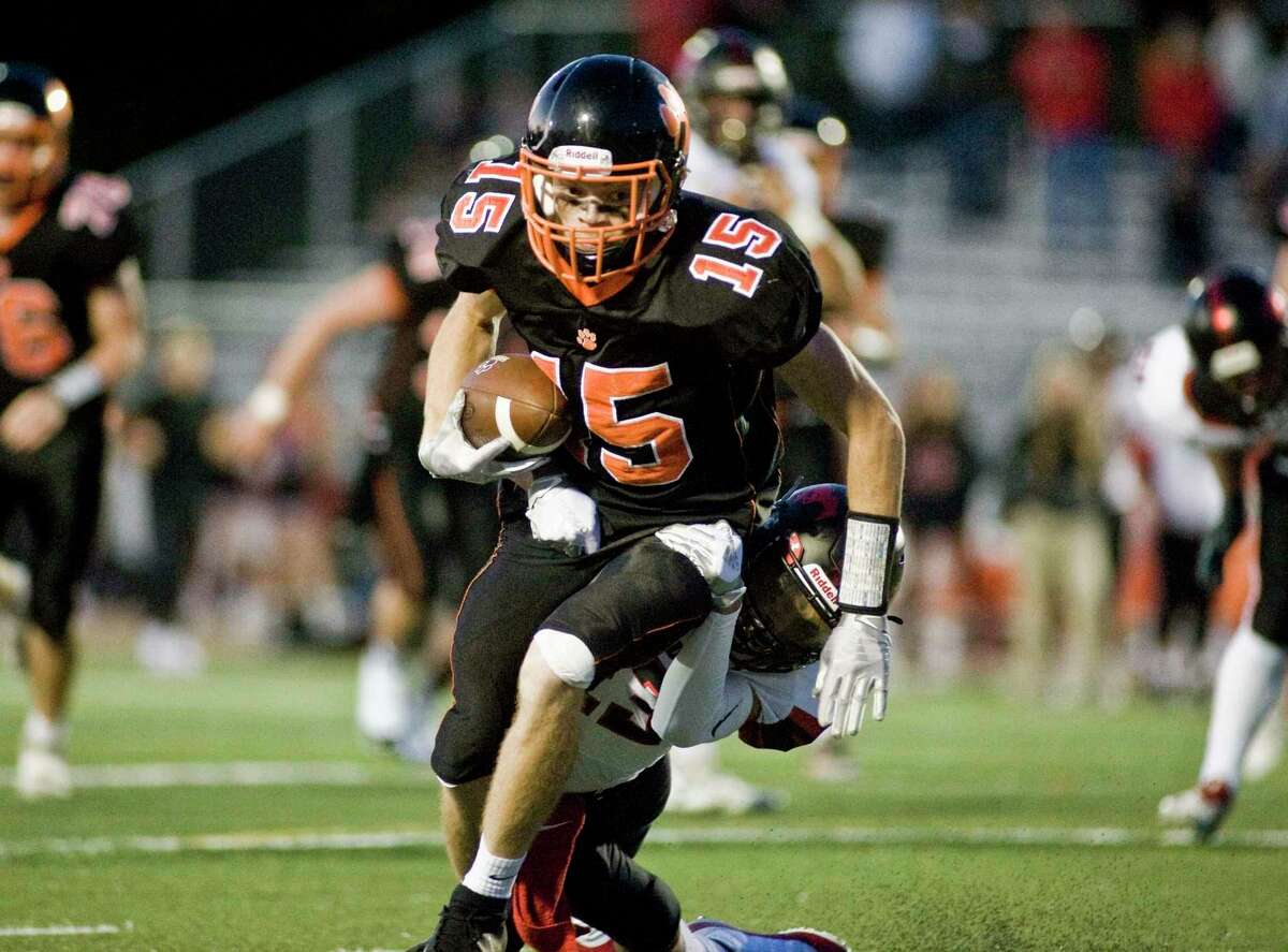 Gianni Gorham runs with the ball after making a catch in Ridgefield's 21-7 win over Fairfield Warde.