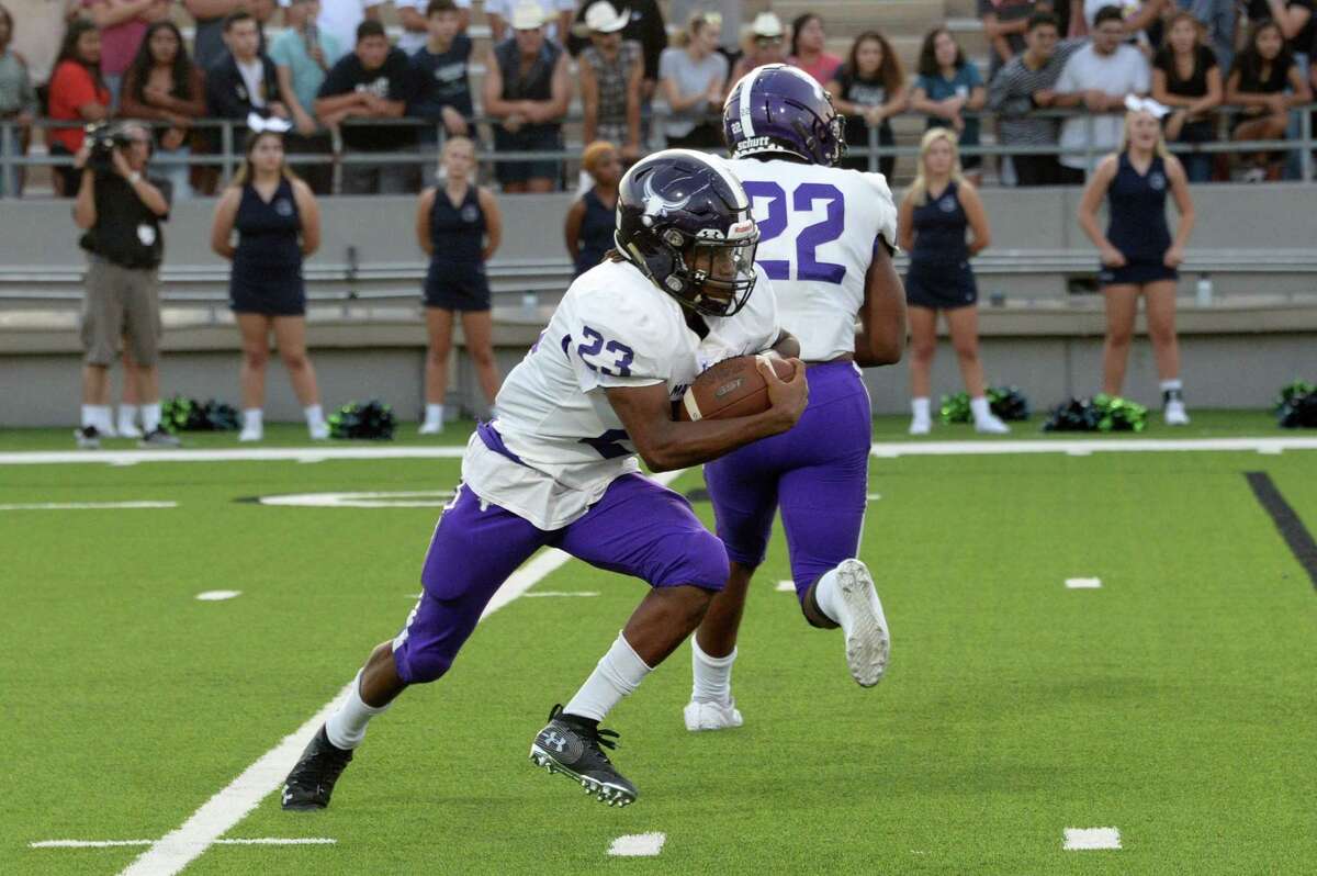 Jaymarcus Wilson (23) of Morton Ranch carries the ball after a fake handoff to Jaelon Moorehead (22) in the second quarter of a high school football game between the Morton Ranch Mavericks and the Cy Ridge Rams on Thursday, September 5, 2019 at Pridgeon Stadium, Houston, TX.