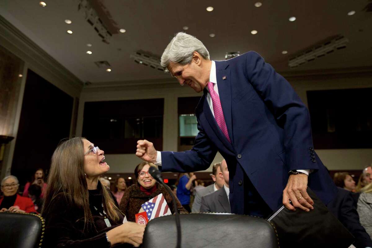 Marca Bristo, president of the U.S. International Council on Disabilities, left, being greeted by John Kerry on Capitol Hill in Washington, Thursday, Nov. 21, 2013, prior to the start of the Senate Foreign Relations Committee hearing on the Disability Treaty. (AP Photo/Jacquelyn Martin)