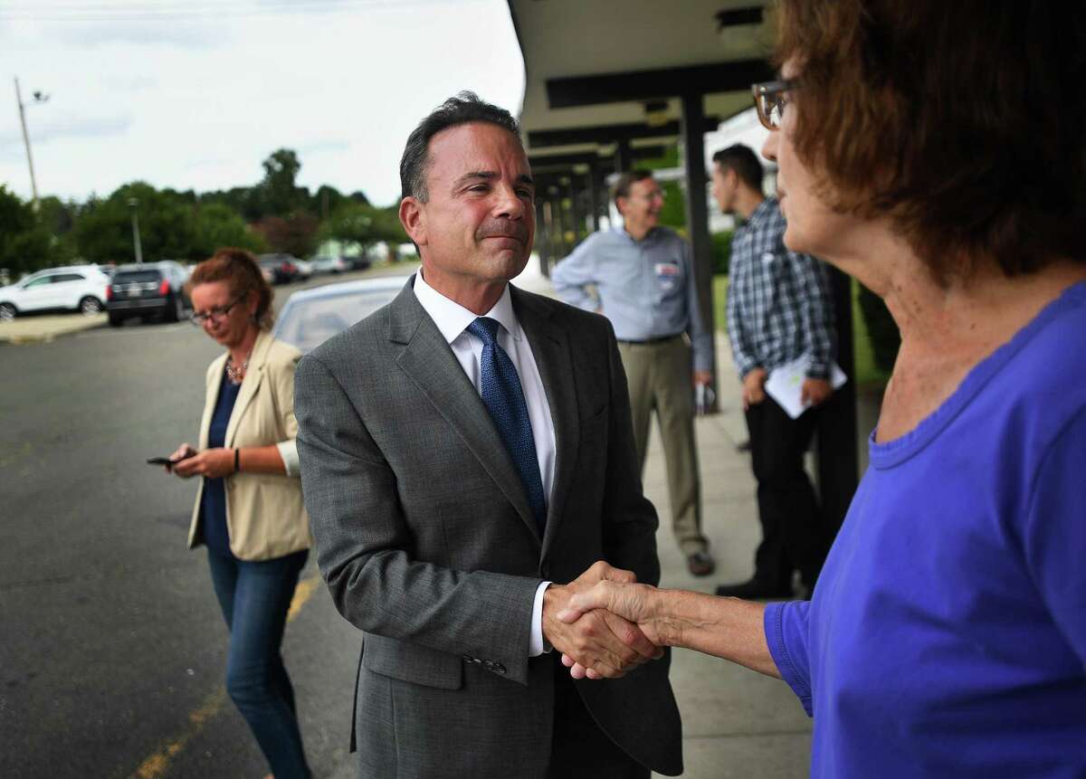 Bridgeport Mayor Joe Ganim greets voter Catherine Zahorsky outside Blackham School during the Bridgeport primary on Monday. He is one of seven white males likely to be running the state’s largest cities after the November election.