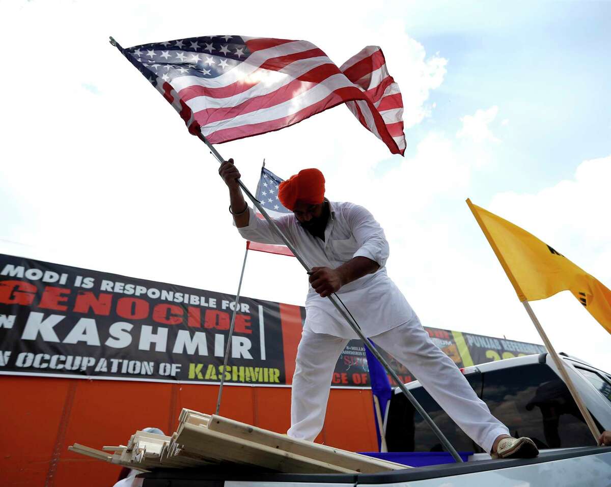 Gagandeep Singh puts American flags on a pickup truck as he and others prepared for a truck rally at the Sikh National Center Gurdwara, Saturday, Sept. 14, 2019, in Houston. The rally is organized by the national human rights organization Sikhs for Justice and Friends of Kashmir, comprising of Kashmiri and Sikh people who are protesting Prime Minister Modi and his forthcoming appearance on Sunday September 22nd at NSG stadium, where 30,000 demonstrators are expected to protest India’s actions in Kashmir and Punjab.
