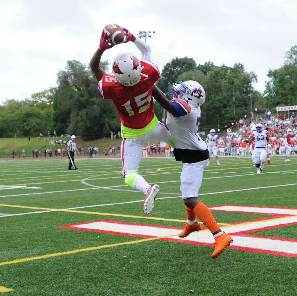 Greenwich's AJ Barber (15) catches a pass for a touchdown against Danbury's Xavier Ross (7) in an FCIAC football season opener at Cardinal Stadium on Sept. 14, 2019 in Greenwich, Connecticut.