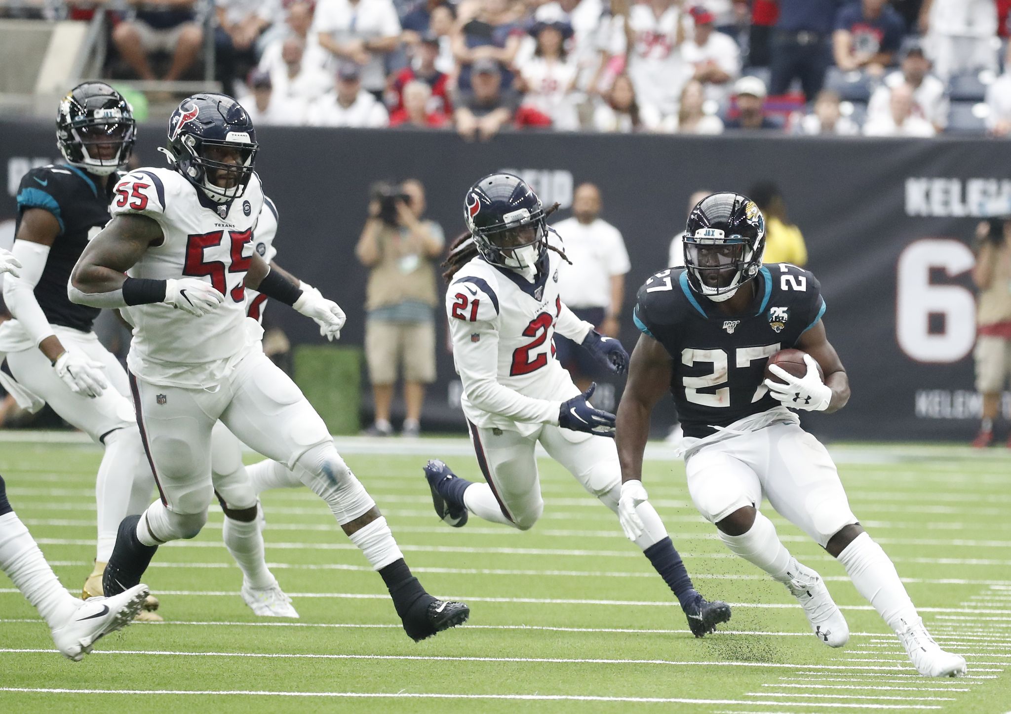 Green Bay Packers running back Jamaal Williams, right, runs with the ball  as Houston Texans defensive end J.J. Watt defends during the first half of  an NFL football game Sunday, Oct. 25