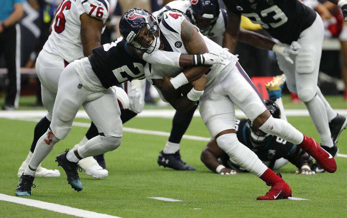 Houston Texans quarterback Deshaun Watson (4) is hit by Jacksonville Jaguars defensive back D.J. Hayden (25) as he runs to the goal line for a 2-yard touchdown during an NFL football game at NRG Stadium on Sunday, Sept. 15, 2019, in Houston.