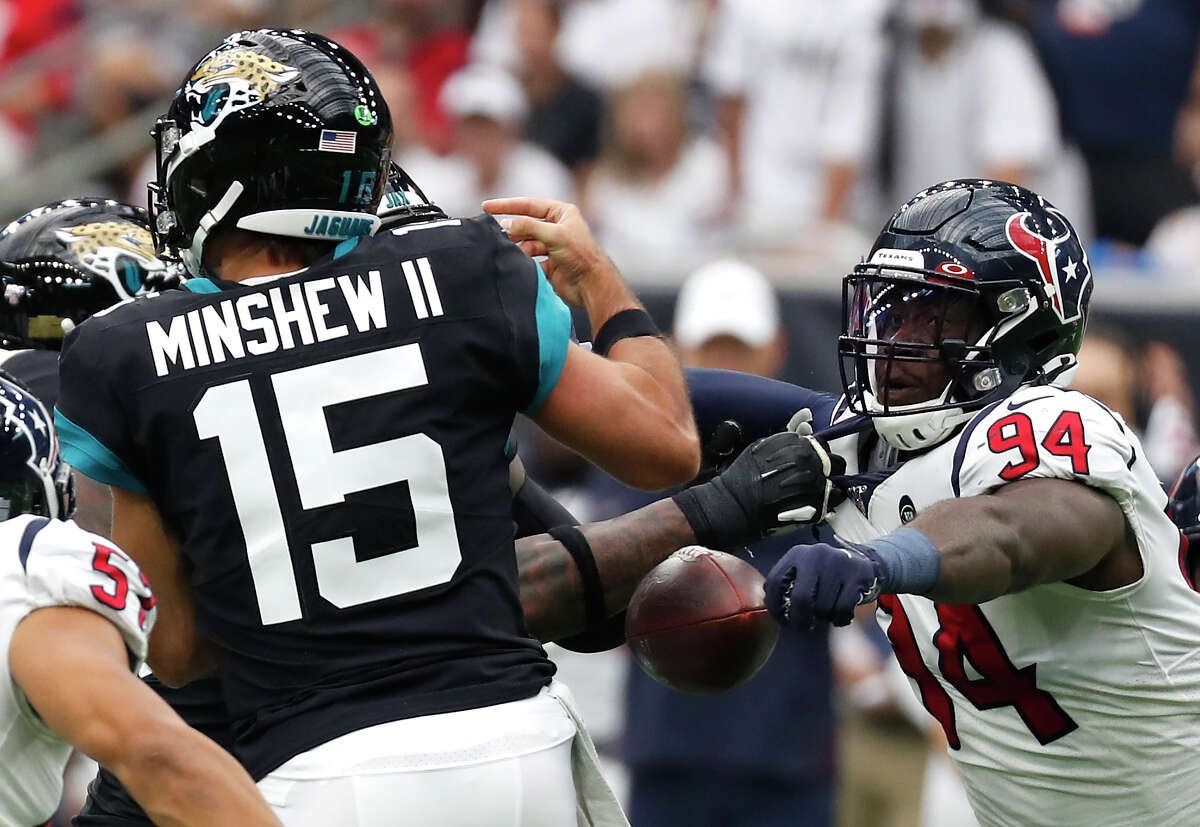 Houston Texans defensive end Charles Omenihu (94) knocks the ball away from Jacksonville Jaguars quarterback Gardner Minshew (15) during an NFL football game at NRG Stadium on Sunday, Sept. 15, 2019, in Houston.