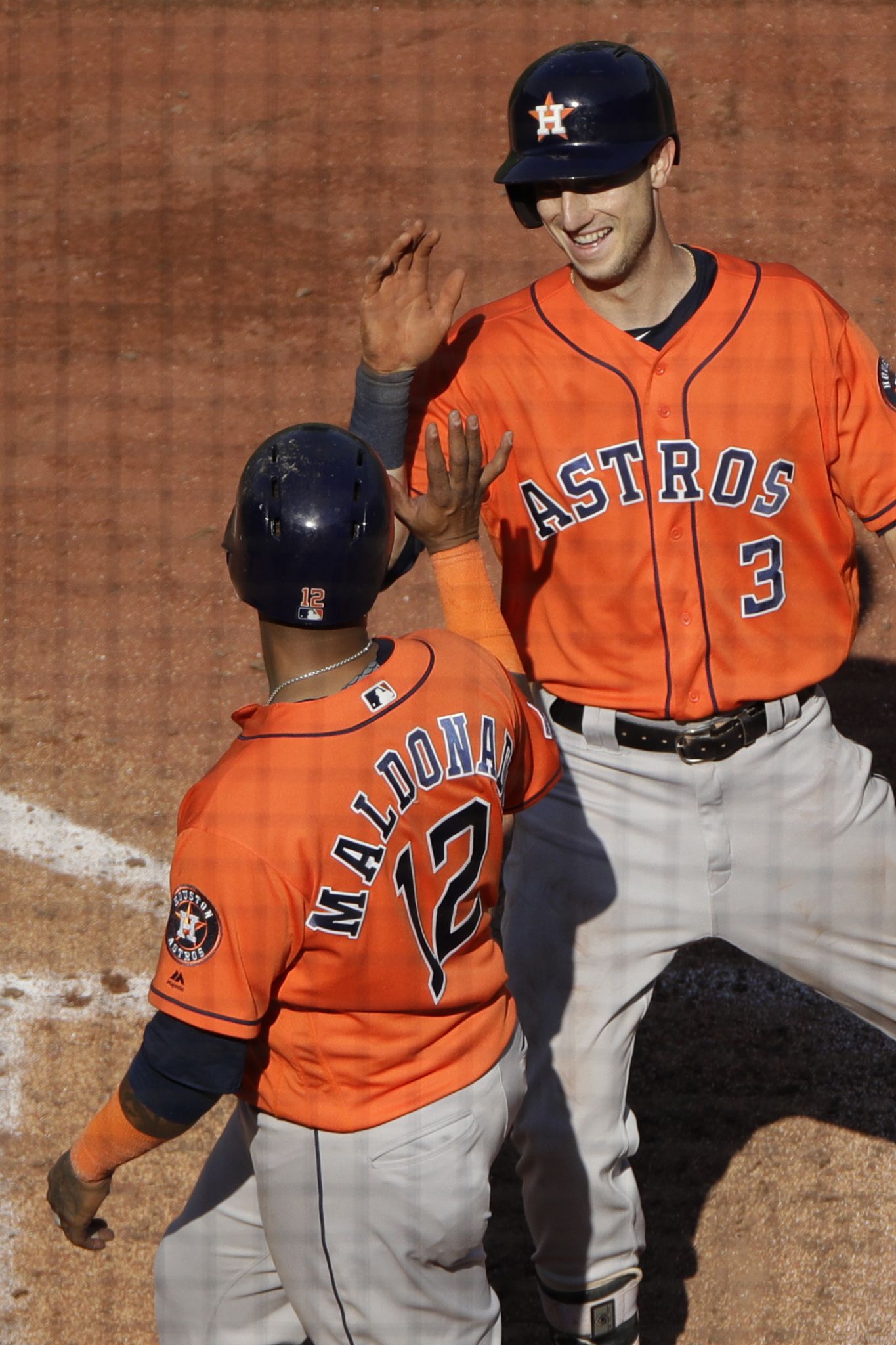 Seattle Mariners third baseman Abraham Toro, left, gets the ball to late as  Houston Astros runner Kyle Tucker (30) safely steals second base during the  eighth inning of a baseball game Monday