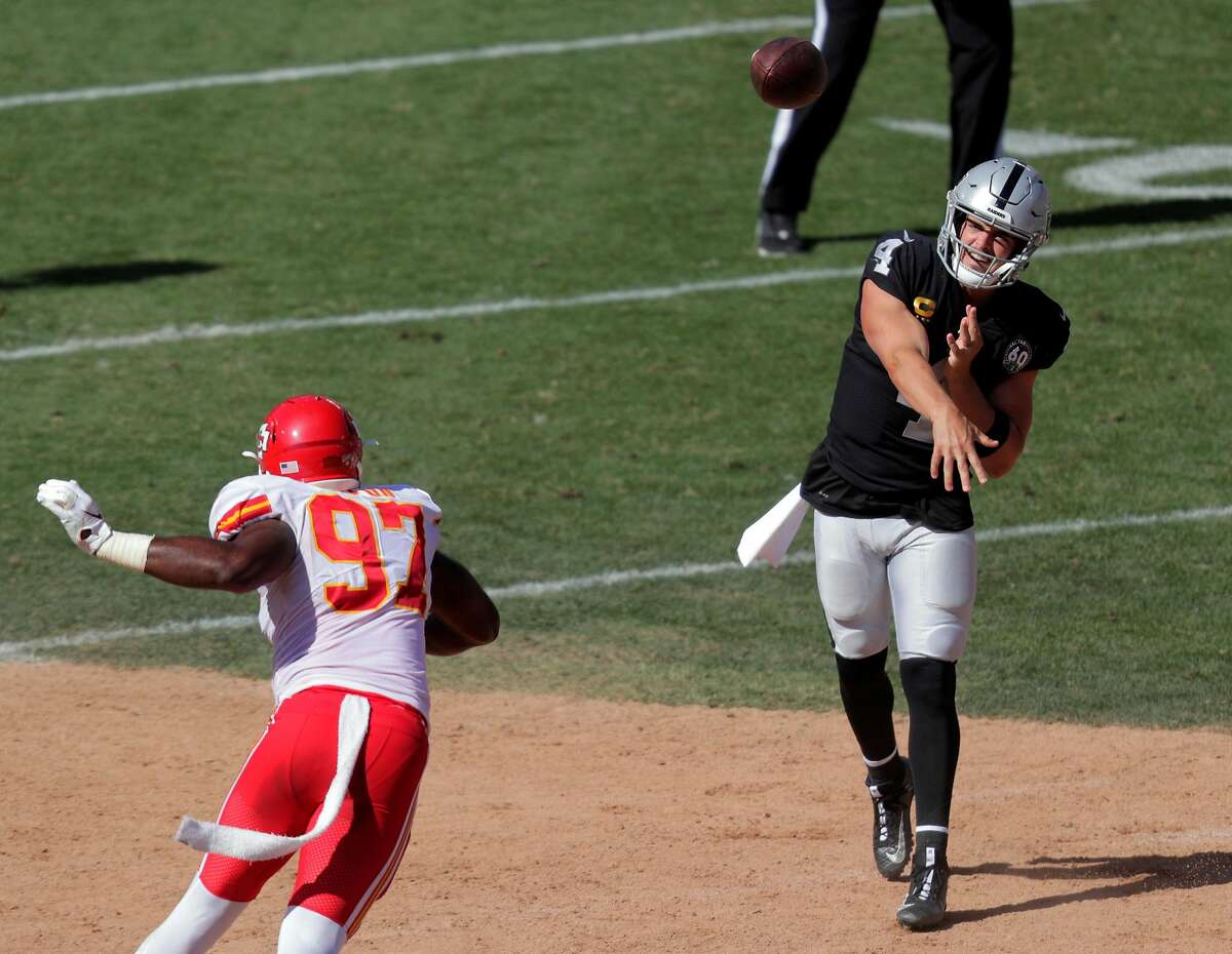 Oakland Raiders quarterback Derek Carr (4) looks at a replay where he fell  over his own offensive lineman during the first half of their NFL game in  Santa Clara, Calif., Thursday, Nov.