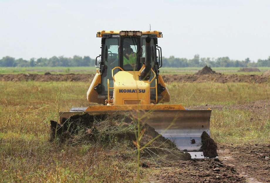 Bulldozers were busy moving dirt in the background during the ceremony that celebrated the groundbreaking for River Ranch, the new master planned community on SH 146 in Dayton. Photo: David Taylor / Staff Photo
