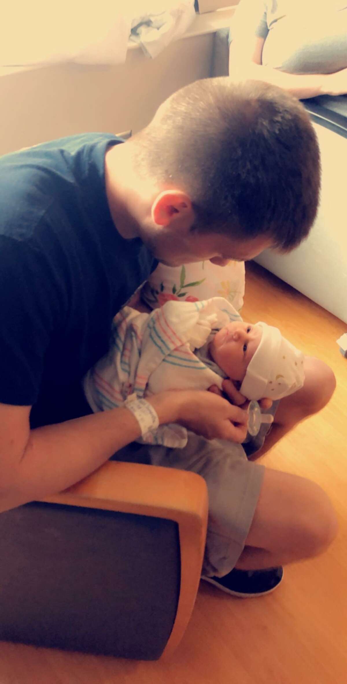 Brandon Hayden holds his newborn daughter, Autumn Rene Hayden.