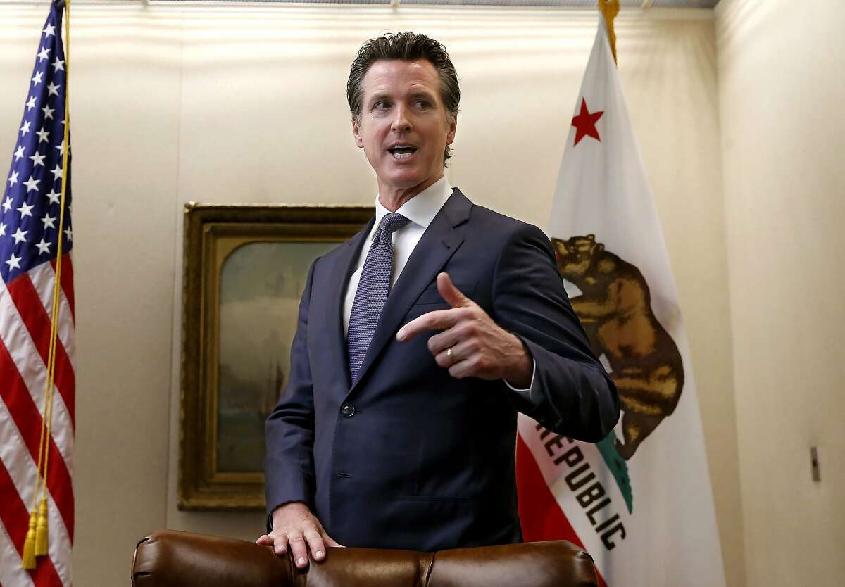 FILE - In this July 11, 2019 file photo, California Gov. Gavin Newsom talks with reporters at his office in Sacramento, Calif. Newsom announced Saturday, Sept. 14, he will buck Democratic legislative leaders by vetoing legislation aimed at stopping the Trump administration from weakening oversight of longstanding federal environmental laws in California. His announcement came less than a day after lawmakers approved the bill on the chaotic final day of the year's legislative session. Newsom said in a statement he fully supports the aims of the bill but argued it wouldn't give California new authority to push back on the Trump administration. (AP Photo/Rich Pedroncelli, File )