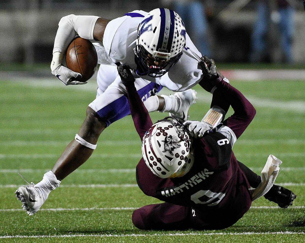 Newton running back Darwin Barlow, top, is tackled by East Bernard linebacker Kameron Matthews during the first half of a 3A State semi-final high school football playoff game, Friday, Dec. 14, 2018, in New Caney, TX.